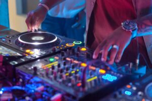 DJ spinning disks at the night club, closeup on hands
