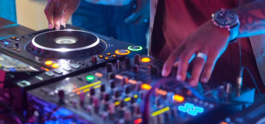 DJ spinning disks at the night club, closeup on hands